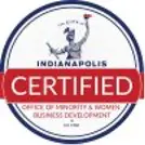 Circular logo with "Indianapolis Certified" text. Includes "Office of Minority & Women Business Development" and an image of a statue holding a torch.